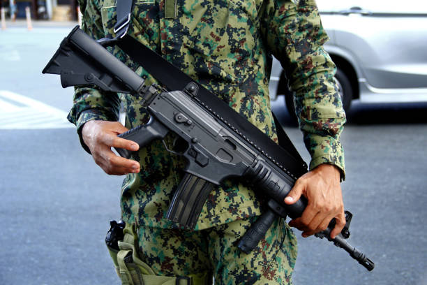 Rifle gun of a soldier in uniform stock photo