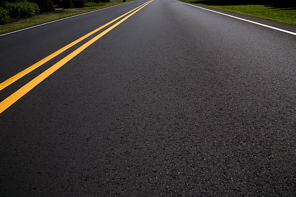 Right Lane of a Freshly Paved Asphalt Road Diminishing Perspective stock photo