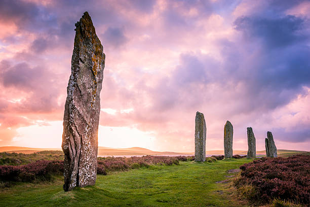 Ring Of Brodgar, Orkney The ancient standing stones of the Ring of Brodgar in the Orkney Islands off the north coast of Scotland, in the evening just at sunset. This monument in the heart of the Neolithic Orkney World Heritage Site is believed to have been built between 4000 and 4500 years ago. Originally built with sixty stones in a circle over 100 metres (over 100 yards) across, fewer than half of the stones still stand. The tallest of the stones is a little over 4.5 metres (15 feet) tall. theasis stock pictures, royalty-free photos & images