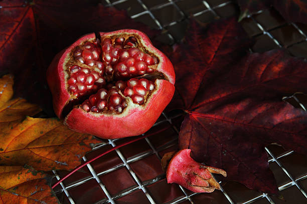Ripe pomegranate, cut into pieces.. stock photo