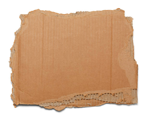 Ripped Cardboard Brown corrugated cardboard torn and isolated on white. cardboard stock pictures, royalty-free photos & images