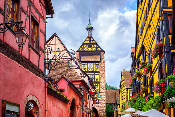 Riquewihr, Alsace, France Colorful houses on a central street in Riquewihr, village on wine route in Alsace, France riquewihr stock pictures, royalty-free photos & images