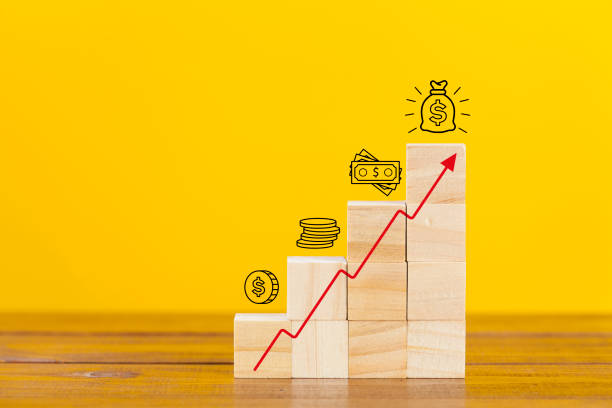 Rising earnings chart Rising earnings chart made from wooden cubes. Business growth success process. capital architectural feature stock pictures, royalty-free photos & images