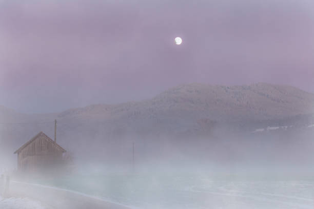 Photo of Rising fog in a moorland with a full moon in autumn