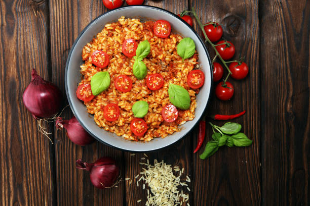 risotto with tomatoes, fresh herbs and parmesan cheese. stock photo