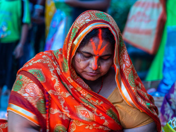 Rituals. April 11,2019. Kolkata. India. An unidentified Indian Bihari hindu woman worship River Ganga at Princep ghat. chhath stock pictures, royalty-free photos & images