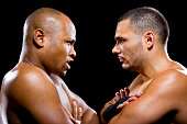 black boxer posing with latino opponent on a black background