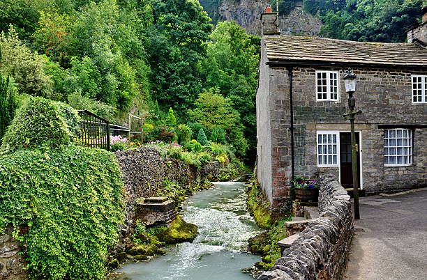 River and cottage in Castleton,Derbyshire View of a stone built cottage by a river in the village of Castleton,Edale, in derbyshire stock pictures, royalty-free photos & images