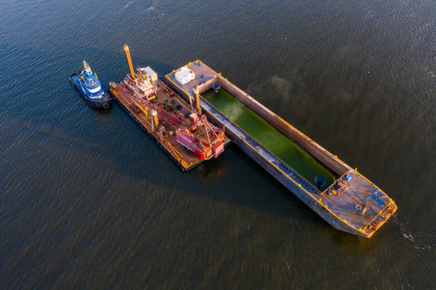 River Dredging Aerial view of dredging operation in the St. Johns River. barge stock pictures, royalty-free photos & images