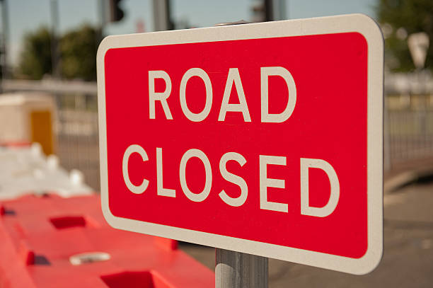 Road Closed Sign Close up of a red & white ROAD CLOSED sign. the end stock pictures, royalty-free photos & images