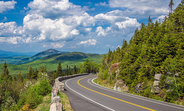 Road in the mountains Mountain road in Adirondack High Peaks adirondack state park stock pictures, royalty-free photos & images