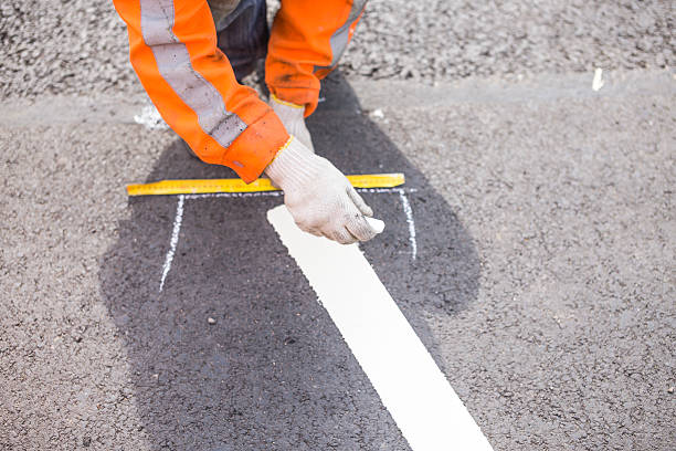 road marking worker painted on the asphalt road marking dividing line road marking stock pictures, royalty-free photos & images