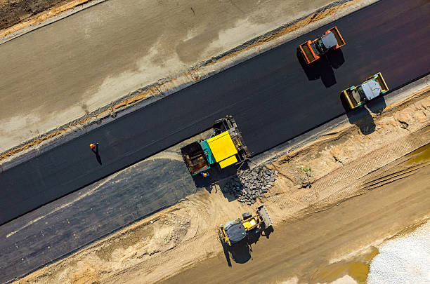 Road rollers working on the construction site aerial view Aerial view on the road rollers working on the new road construction site conveyor belt photos stock pictures, royalty-free photos & images