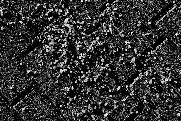 Road Salt on Pavement in Black and White stock photo