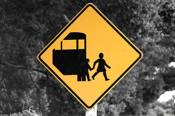 Road sign school bus in New Zealand stock photo