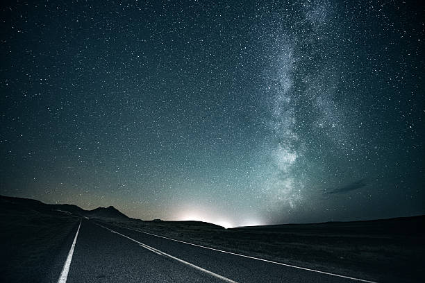 Road trip under the milky way Lonely road under the milky way eternity stock pictures, royalty-free photos & images