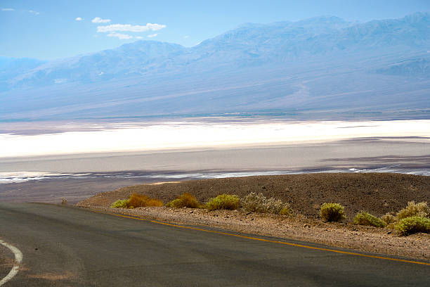 road view on salt basin and mountains in Death Valley stock photo