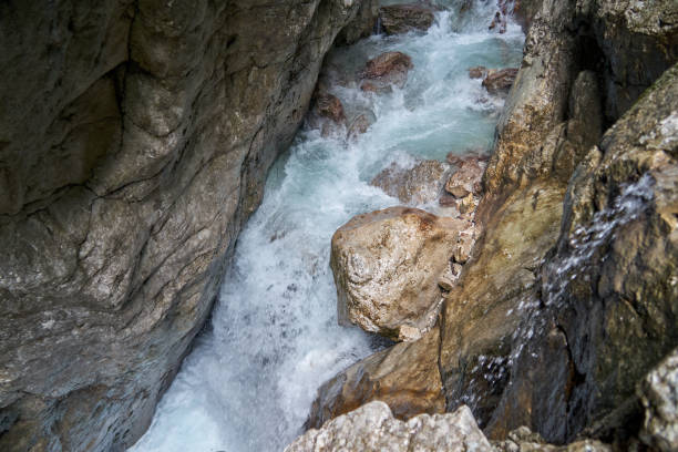 een brullende torrent met turquoise water en wit schuim tussen smalle rotsen - fluisterboot stockfoto's en -beelden