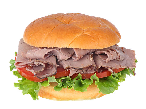 Roast Beef Sandwich Roast beef sandwich with lettuce and tomato isolated on white roast beef sandwich stock pictures, royalty-free photos & images