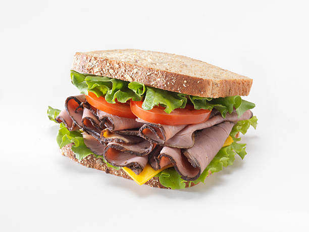 Roast Beef Sandwich Roast Beef Sandwich with Lettuce Tomato and Cheddar Cheese - Photographed on a Hasselblad H3D11-39 megapixel Camera System roast beef sandwich stock pictures, royalty-free photos & images