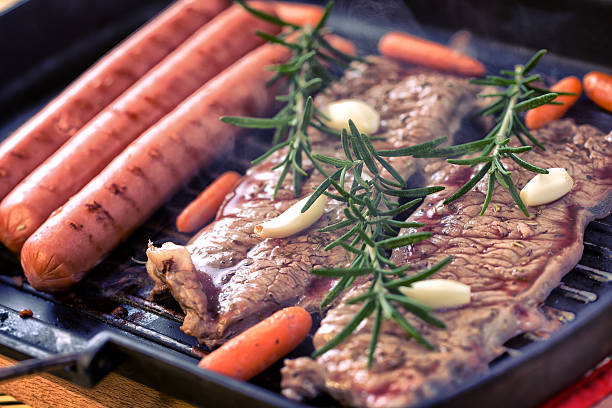 Roast beef with sausage and carrots stock photo
