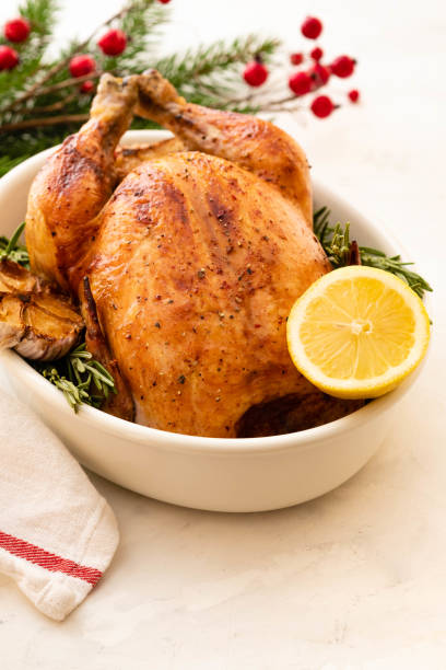 Roast chicken with lemons, garlic and rosemary for Christmas. Christmas concept. stock photo