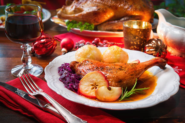 Roast duck leg Roast duck with dumplings, red cabbage and apples duck meat stock pictures, royalty-free photos & images