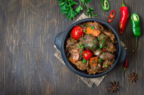 Roast turkey liver with vegetables in a pot. Delicious dietary meal. Rustic style. Top view. Copy space. Roast turkey liver with vegetables in a pot. Delicious dietary meal. Rustic style. Top view. Copy space. Beef Liver Grilled Recipe stock pictures, royalty-free photos & images