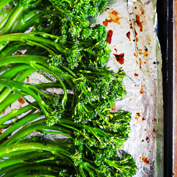 Roasted Broccolini on Baking Sheet Roasted Broccolini on Tin Foil and Baking Sheet broccoli rabe stock pictures, royalty-free photos & images