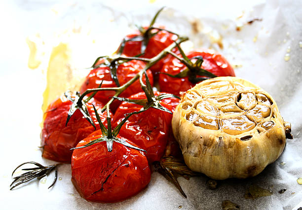Roasted cherry tomatoes and garlic stock photo