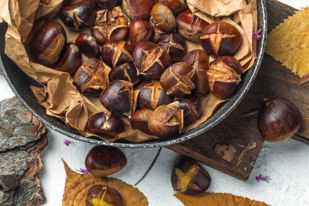 Roasted chestnuts served in a pan. stock photo