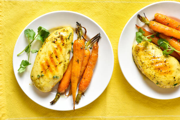 Roasted chicken breast with carrots stock photo