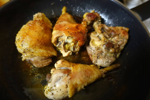 Roasted chicken thighs being cooked in a Dutch oven stock photo