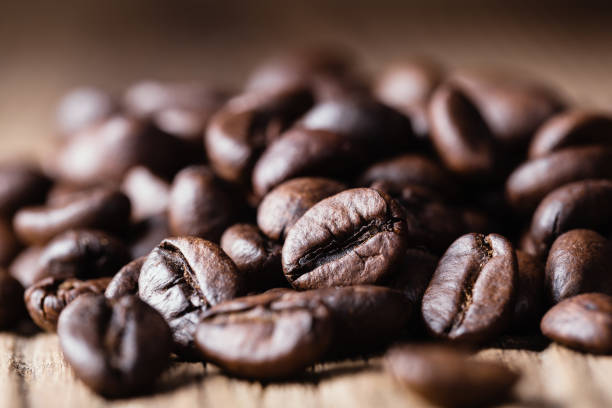 Roasted coffee beans on wooden background. stock photo