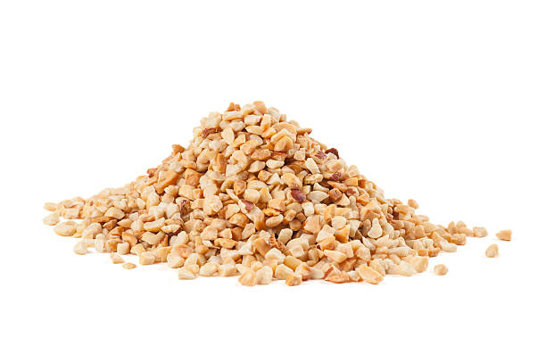 Roasted crushed peanuts Heap of roasted crushed peanuts on white background crushed stock pictures, royalty-free photos & images