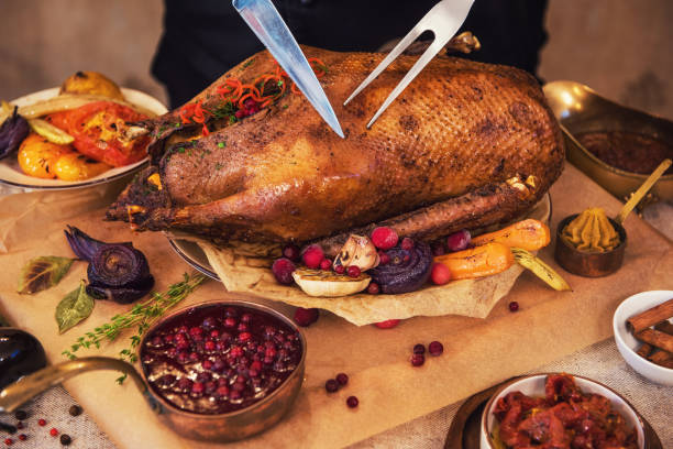 Roasted goose with herbs berries and vegetables Roasted stuffed goose with herbs berries and vegetables. Ready to Christmas time. goose meat photos stock pictures, royalty-free photos & images