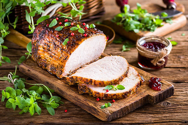 Roasted pork loin with cranberry and marjoram stock photo