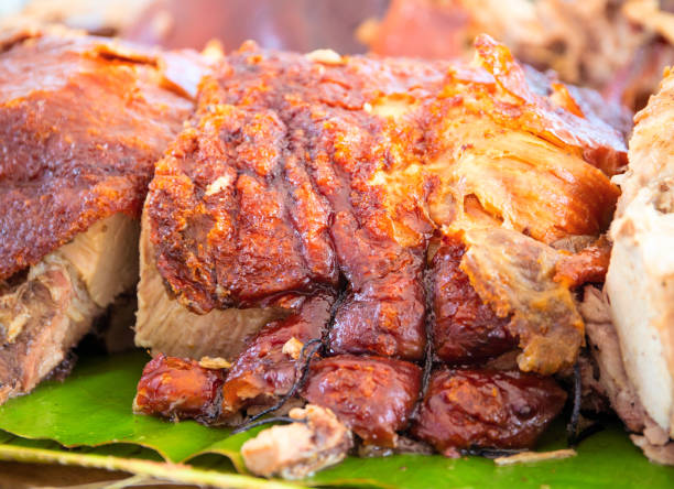 Roasted pork meat cooked on grill. Traditional cuisine. Sliced pork barbecue with gold skin. Spanish dish lechon stock photo