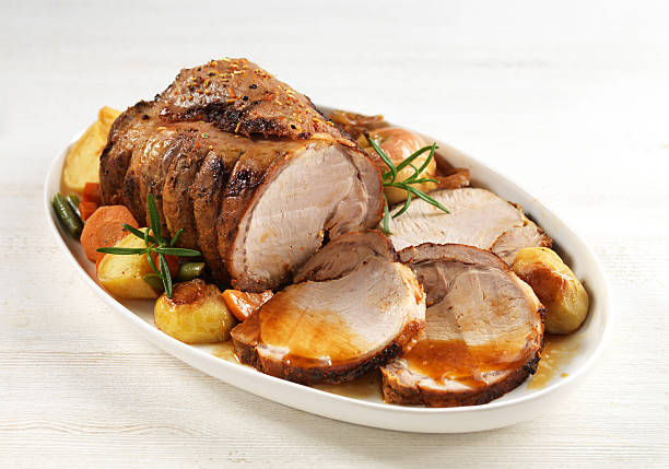 roasted pork roasted pork on white plate roast dinner stock pictures, royalty-free photos & images