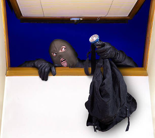 robber enters the house stock photo