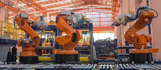 Robots welding in a production line stock photo