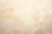 istock rock abstract beige wall background 464895072