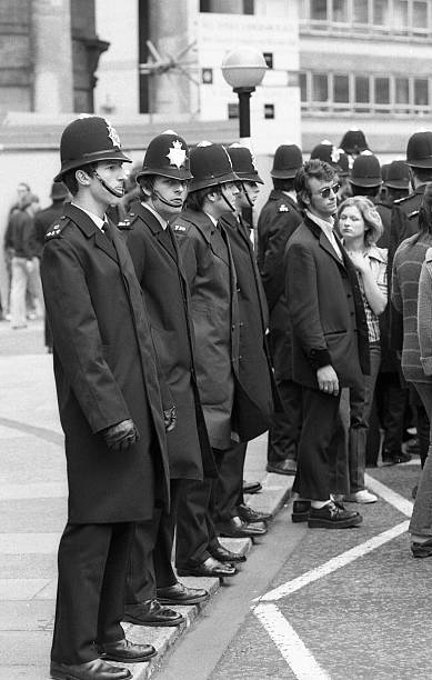 Rock and Roll Radio Campaign march, London "London, England - May 15, 1976: Metropolitan police officers aid crowd control during the Rock and Roll Radio Campaign march in Central London. The campaign aimed to get more Rock and Roll music played on British radio." 20th century stock pictures, royalty-free photos & images