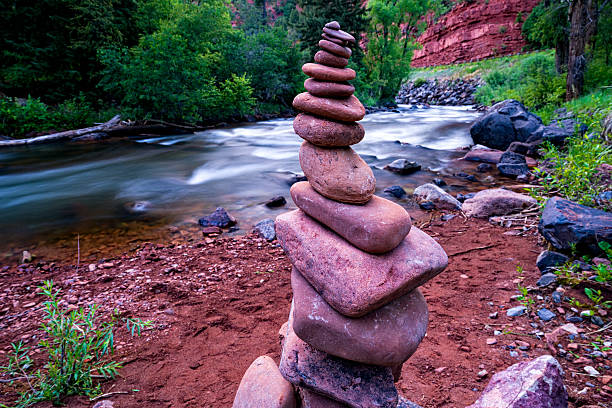 Rock Cairn Along the Shore of the Fryingpan River Rock Cairn Along the Shore of the Fryingpan River - Scenic red-rock canyon landscape near Aspen and Basalt, Colorado USA. Balance theme. basalt stock pictures, royalty-free photos & images