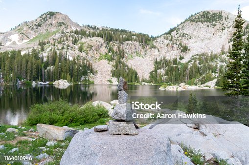 istock Rock Cairn Overlooking a Panoramic Scene at the Shore of a Mountain Lake - Lake Mary in the Wasatch Mountains of Utah 1164010946