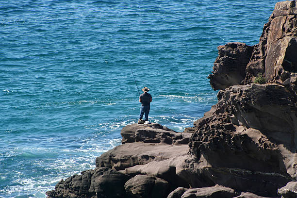 Rock fisherman stock photo