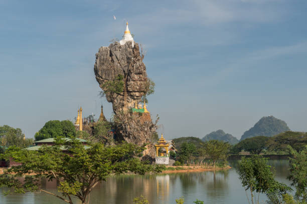 Rock formation topped with Kyaut Ka Latt Pagoda in  Hpa-An, Myanmar stock photo