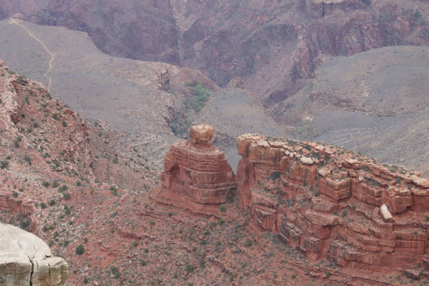 Rock Formation with a Rounded Rock on Top within the Canyons of the Grand Canyon stock photo