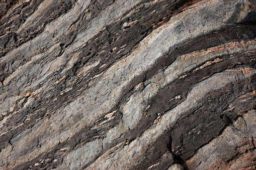 Rock formations of the Maine coast.The geologic history recorded in Maine’s bedrock covers close to 1.5 billion years – approximately one-third of the total age of the Earth. Minimalist geology background.