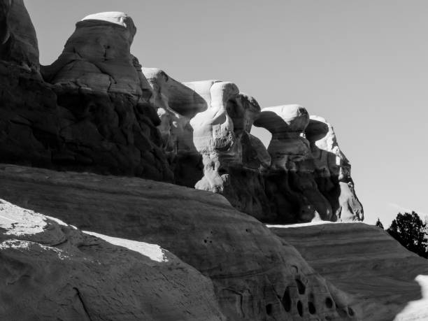 Rock formations of Devils Garden,  Escalante, Utah, in Black and white The Bizarre, weathered rock formations of the Devil"u2019s Garden, Escalante, Utah, USA, in Black and white. This area, located on the Hole-in-the-Rock Road, consist of various hoodoos, natural arches, and other sandstone formations. These strange formations consist of orange and yellow colored Entrada Sandstone situated on top of the beige colored Navajo sandstone and were shaped by erosion and weathering. garfield county utah stock pictures, royalty-free photos & images